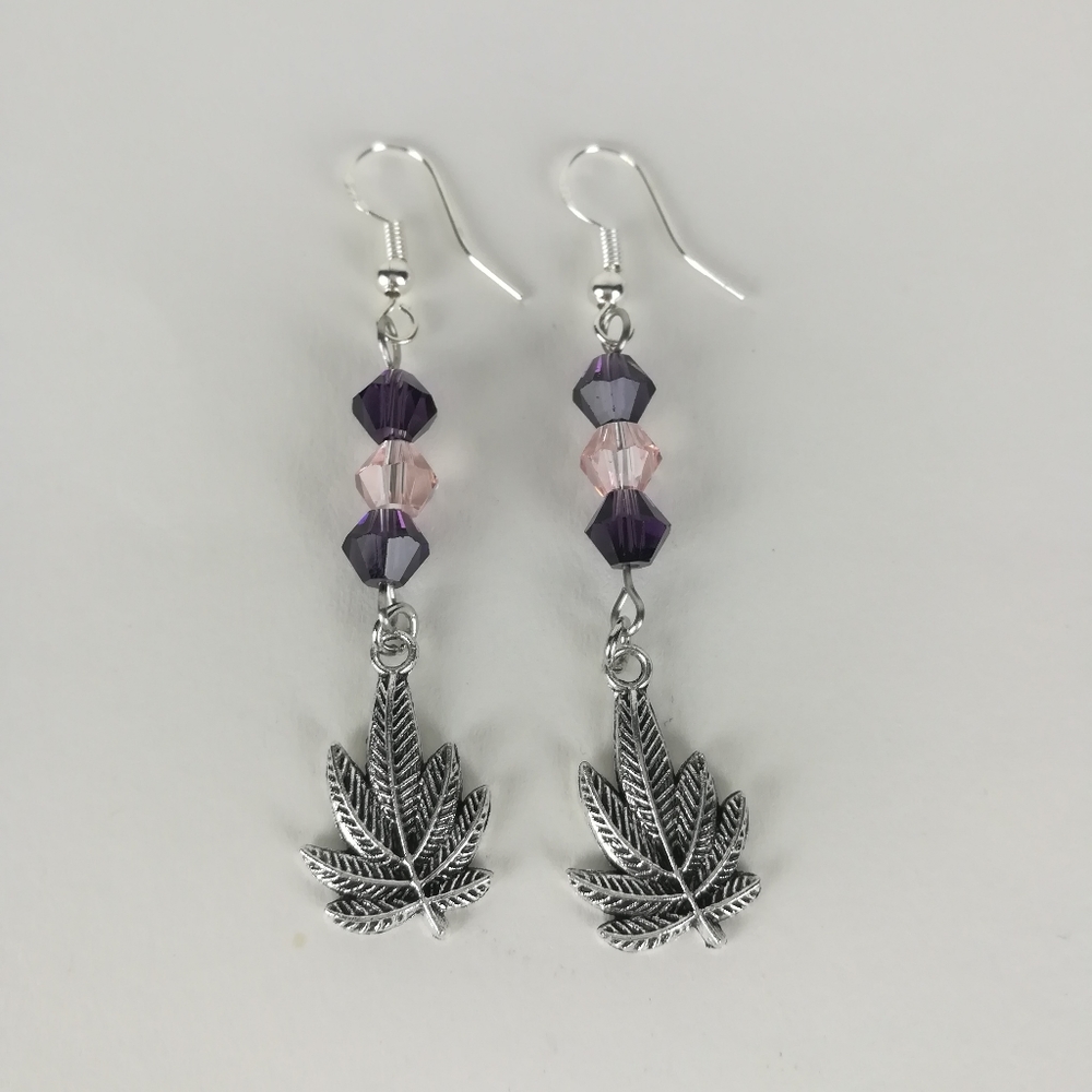 Simple cannabis leaf earrings made with pink and purple faceted glass beads
